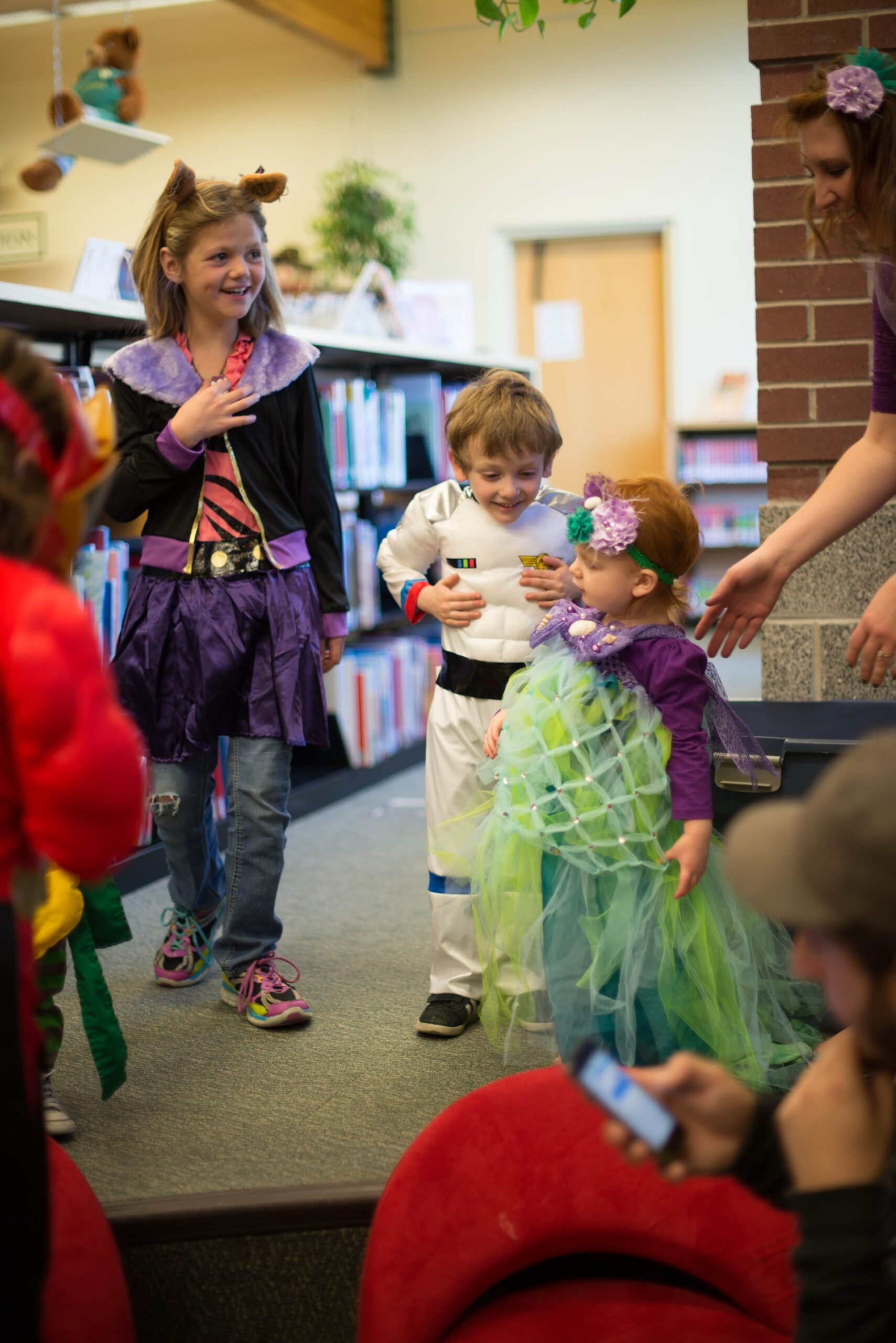 children in different costume standing inside room